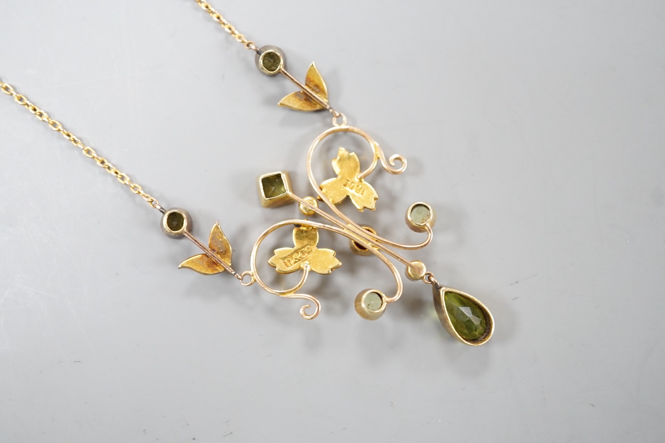 An Edwardian 15ct, peridot, seed pearl and ruby set drop pendant necklace, 46cm, gross weight 6.9 grams.